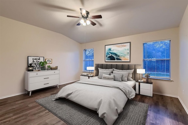 bedroom featuring a ceiling fan, vaulted ceiling, baseboards, and wood finished floors