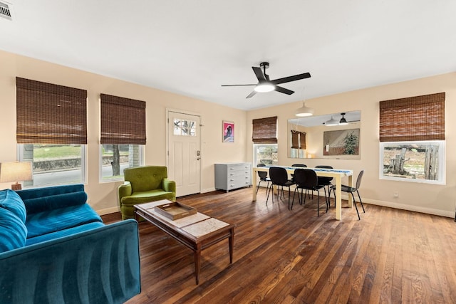 living area featuring hardwood / wood-style floors, plenty of natural light, and visible vents