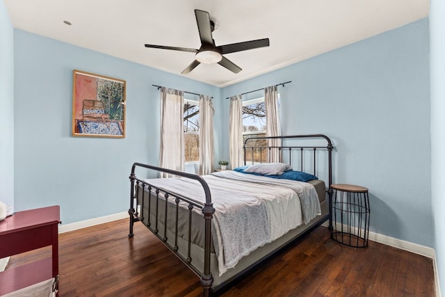 bedroom with a ceiling fan, baseboards, and wood finished floors