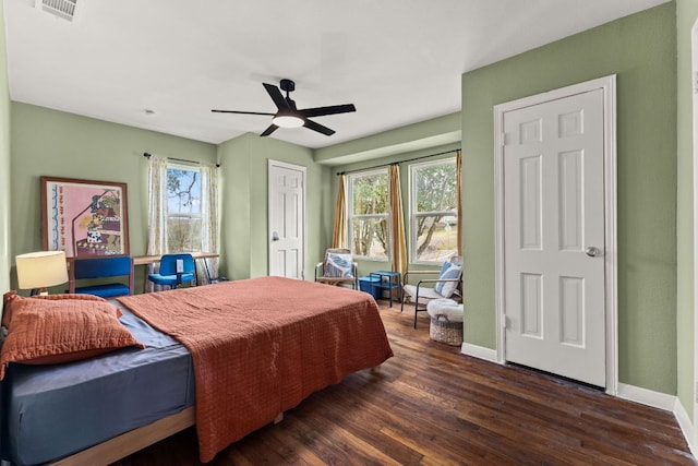 bedroom with dark wood-style floors, baseboards, multiple windows, and visible vents