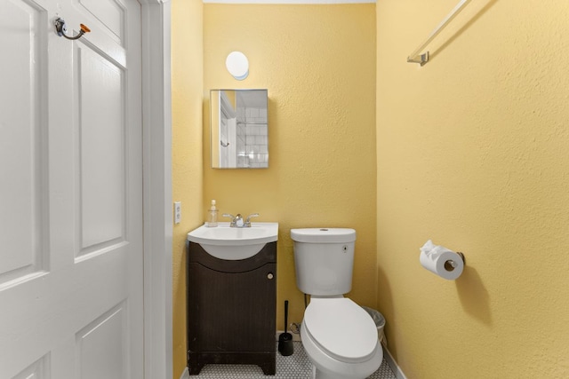 bathroom with toilet and vanity