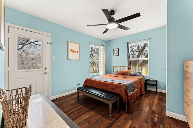 bedroom with ceiling fan, baseboards, and dark wood-style flooring