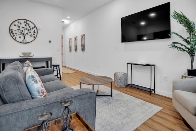 living room with baseboards and wood finished floors