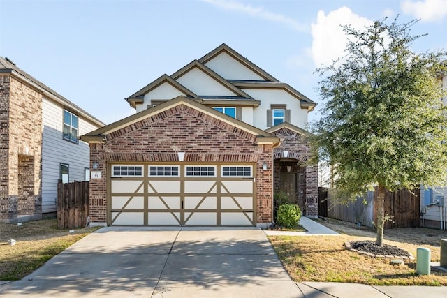 view of front facade with brick siding, stucco siding, an attached garage, fence, and driveway