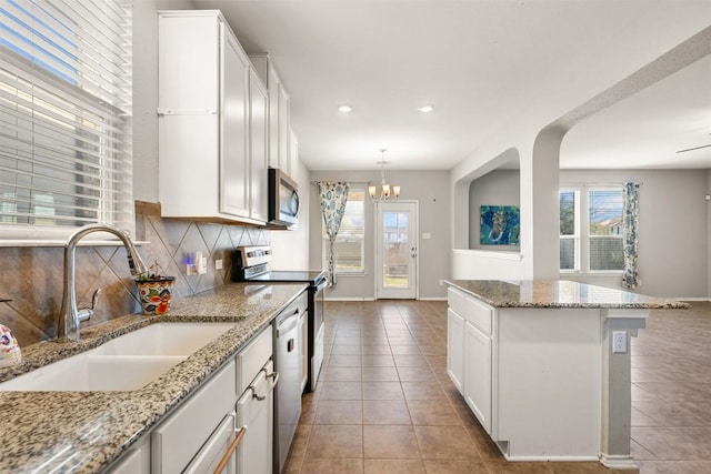 2950 E Old Settlers Blvd Unit 55, Round Rock, TX 78665 - kitchen with appliances with stainless steel finishes, plenty of natural light, decorative backsplash, tile patterned flooring, and recessed lighting