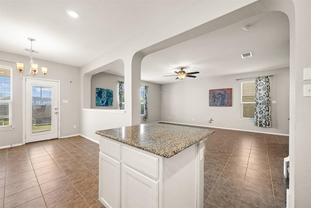 2950 E Old Settlers Blvd Unit 55, Round Rock, TX 78665 - kitchen with tile patterned flooring, a ceiling fan, white cabinets, a center island, and open floor plan