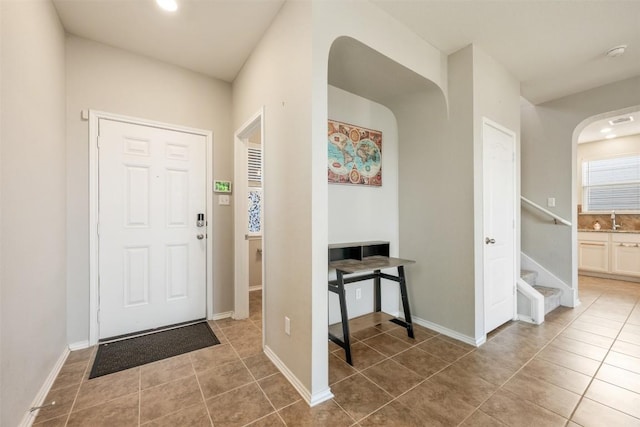 entrance foyer with stairway, tile patterned flooring, visible vents, and baseboards