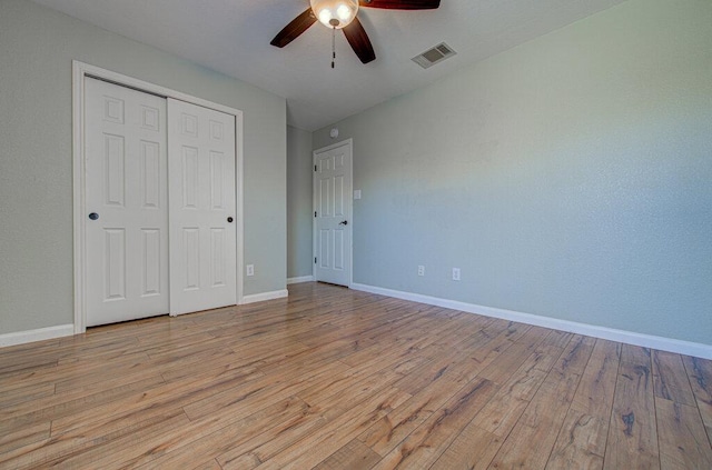 unfurnished bedroom with light wood finished floors, baseboards, and visible vents