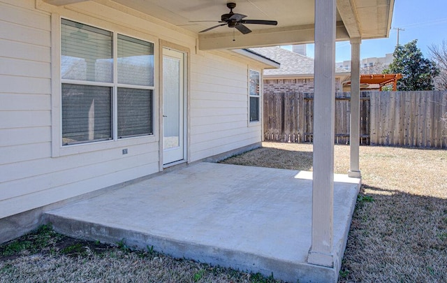 view of patio / terrace with ceiling fan and fence