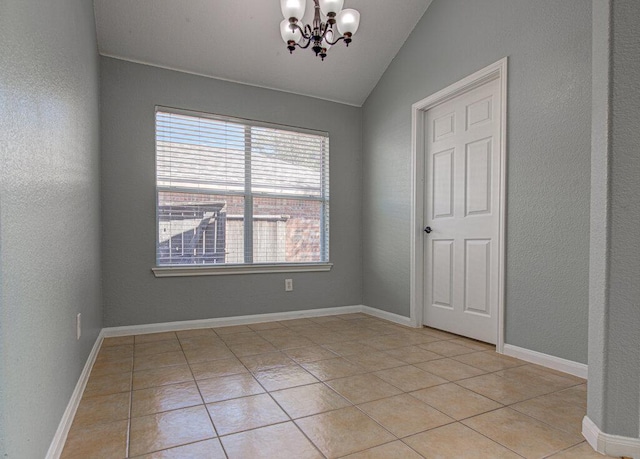 spare room featuring an inviting chandelier, baseboards, vaulted ceiling, and light tile patterned flooring