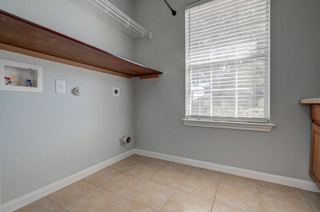 laundry room with light tile patterned floors, laundry area, washer hookup, baseboards, and electric dryer hookup