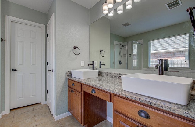 full bath featuring a shower stall, visible vents, and a sink