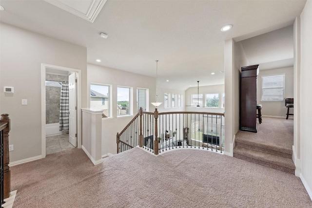 hallway featuring baseboards and a wealth of natural light