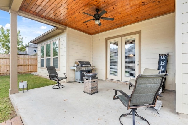 view of patio / terrace featuring fence, area for grilling, and ceiling fan