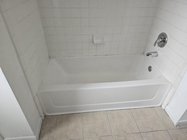 full bathroom featuring tile patterned flooring and a tub