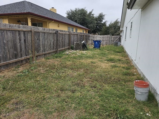 view of yard with a fenced backyard