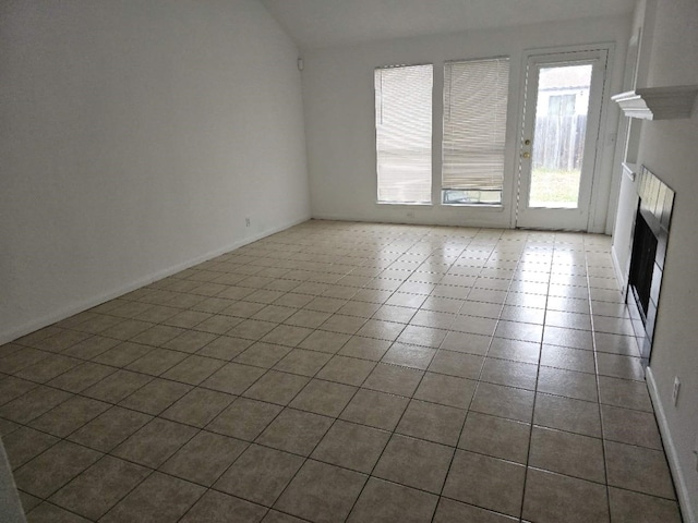 unfurnished living room with vaulted ceiling and a fireplace