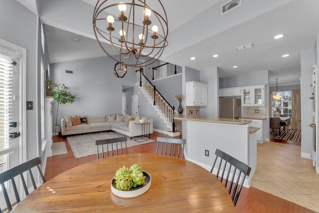 dining space featuring light tile patterned floors, visible vents, stairway, a chandelier, and recessed lighting