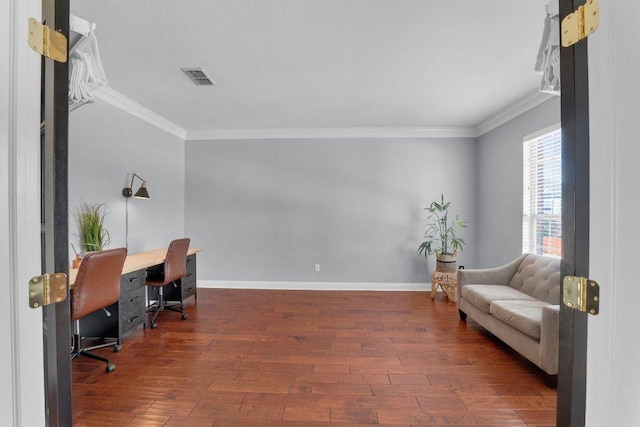 office space with hardwood / wood-style flooring, baseboards, visible vents, and ornamental molding