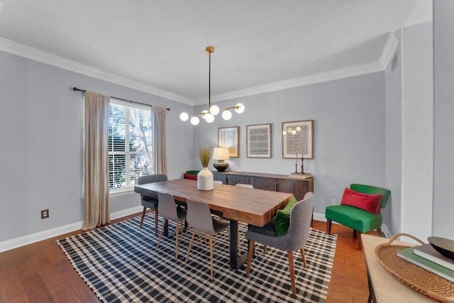 dining area featuring dark wood-style floors, ornamental molding, and baseboards