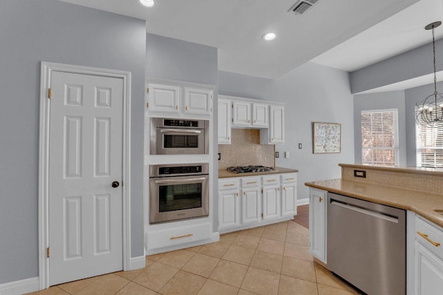 kitchen with gas stovetop, light tile patterned floors, visible vents, decorative backsplash, and dishwasher