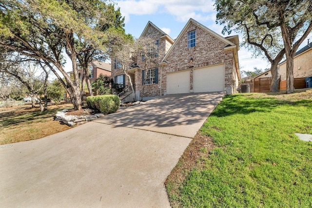 traditional-style home with concrete driveway, brick siding, a front lawn, and an attached garage