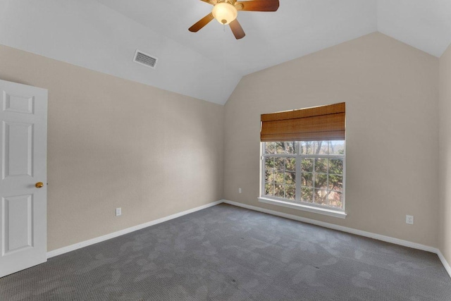 spare room with baseboards, visible vents, a ceiling fan, vaulted ceiling, and carpet flooring