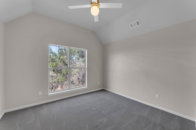 unfurnished room with baseboards, visible vents, ceiling fan, vaulted ceiling, and dark colored carpet