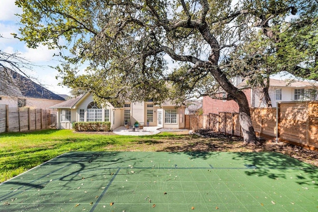 back of house with a patio area, a fenced backyard, and a lawn