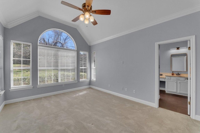 unfurnished room with light carpet, a healthy amount of sunlight, baseboards, and crown molding