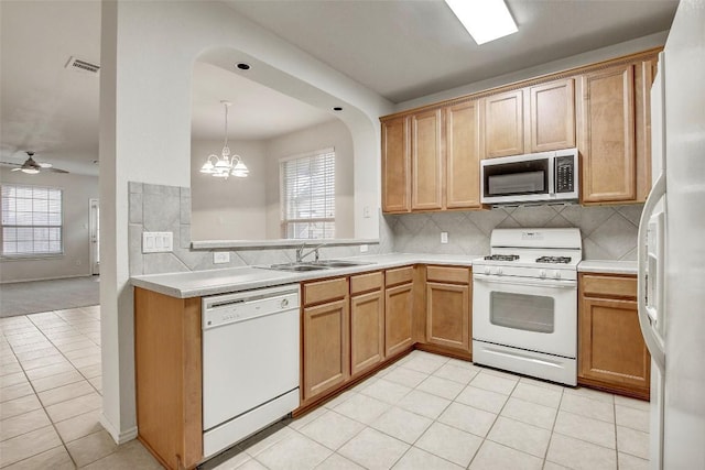 kitchen with white appliances, a sink, visible vents, and a healthy amount of sunlight