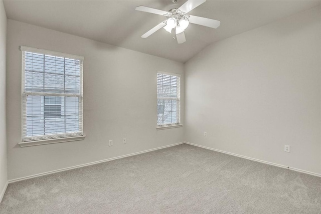 unfurnished room with lofted ceiling, ceiling fan, baseboards, and carpet flooring