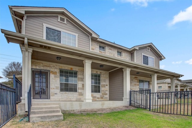 view of front facade with stone siding, covered porch, and fence