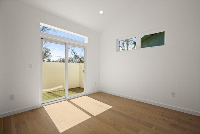3402 Goodwin Ave Unit 1, Austin, TX 78702 - unfurnished room with wood finished floors, baseboards, recessed lighting, and vaulted ceiling