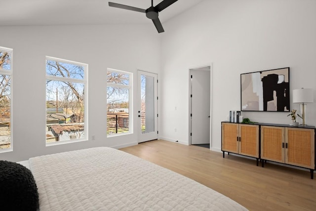 3402 Goodwin Ave Unit 1, Austin, TX 78702 - bedroom with light wood finished floors, high vaulted ceiling, baseboards, access to exterior, and ceiling fan