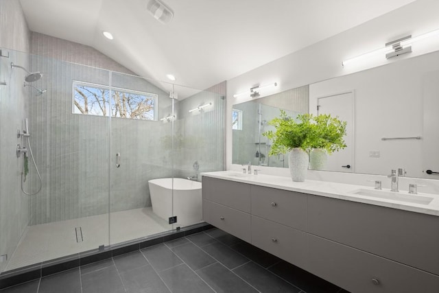 3402 Goodwin Ave Unit 1, Austin, TX 78702 - full bathroom with vaulted ceiling, tile patterned flooring, a stall shower, double vanity, and a freestanding tub