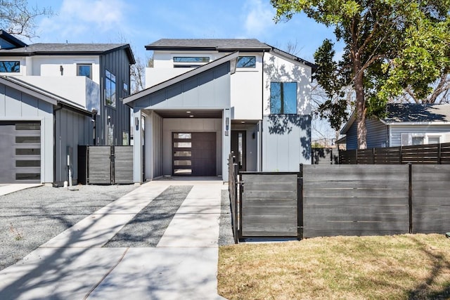 3402 Goodwin Ave Unit 1, Austin, TX 78702 - contemporary house featuring concrete driveway, fence, an attached garage, and a gate