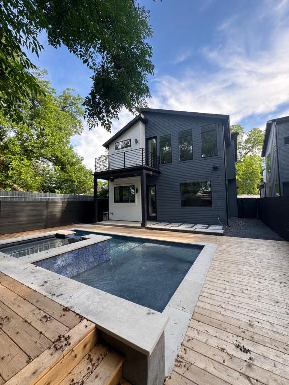 3402 Goodwin Ave Unit 1, Austin, TX 78702 - view of pool featuring a fenced backyard, a wooden deck, and a pool with connected hot tub