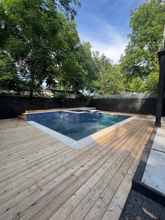 3402 Goodwin Ave Unit 1, Austin, TX 78702 - view of pool with a deck, a fenced backyard, and a pool with connected hot tub