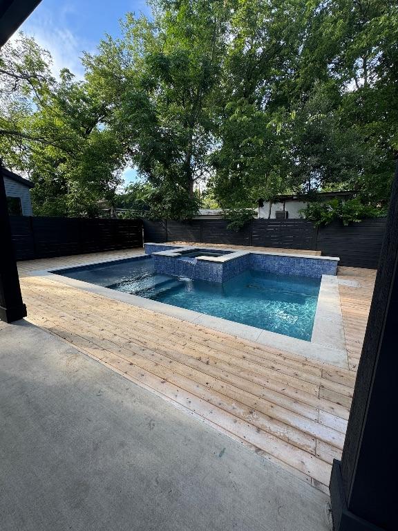 3402 Goodwin Ave Unit 1, Austin, TX 78702 - view of swimming pool featuring a fenced backyard, a deck, and a pool with connected hot tub