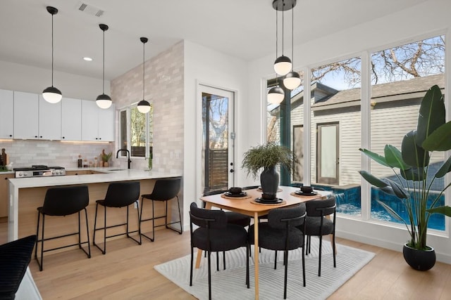 dining space featuring recessed lighting, visible vents, and light wood-style floors