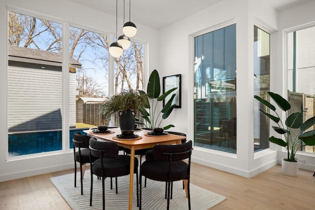 dining room with baseboards and wood finished floors