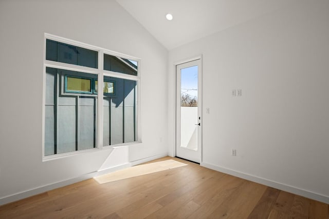 entryway featuring baseboards, vaulted ceiling, wood finished floors, and recessed lighting