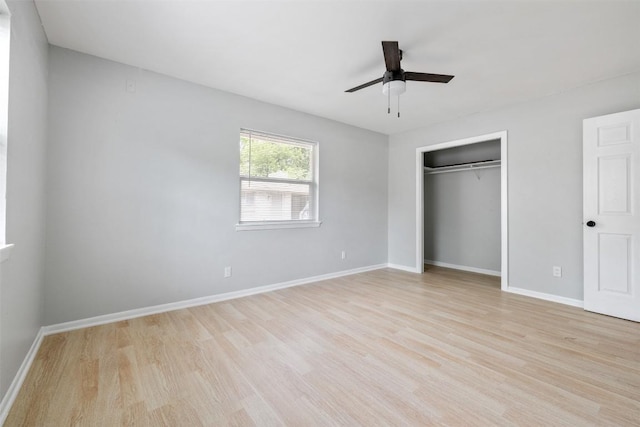 unfurnished bedroom with light wood finished floors, a closet, a ceiling fan, and baseboards