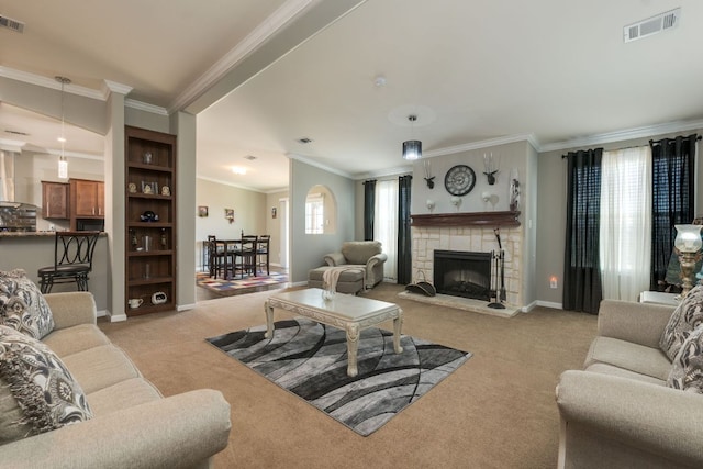 carpeted living area featuring a fireplace, visible vents, crown molding, and baseboards