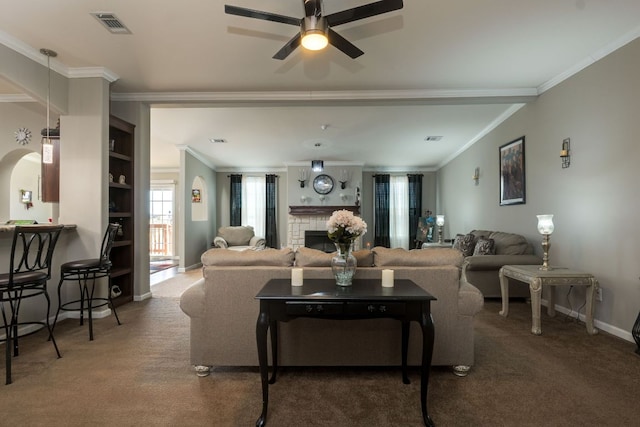 living area with carpet, a fireplace, baseboards, and crown molding