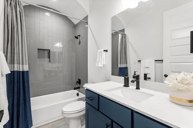 bathroom with toilet, tile patterned flooring, shower / bath combination with curtain, and vanity