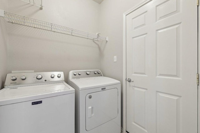 clothes washing area with laundry area and washer and clothes dryer