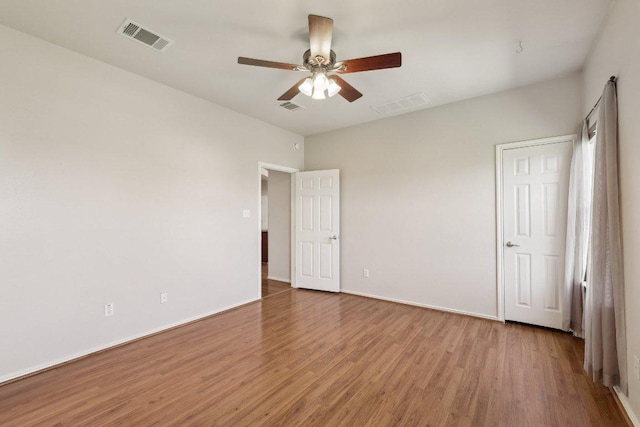 unfurnished bedroom with baseboards, visible vents, and wood finished floors