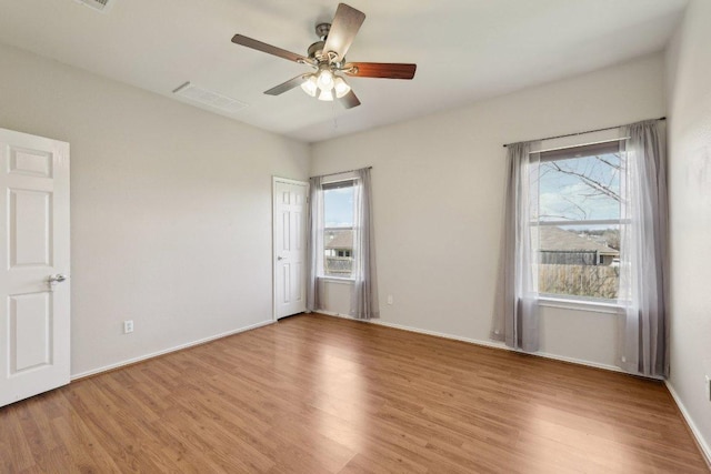 unfurnished bedroom featuring light wood finished floors, visible vents, and baseboards